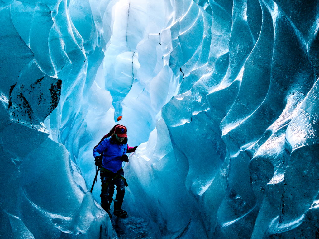 Hikers walking through a crevasse in the clacier of Solheimajokull in south coast of Iceland