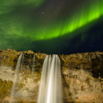 Aurora borealis or northern lights over Seljalandsfoss waterfall on the south coast of Iceland