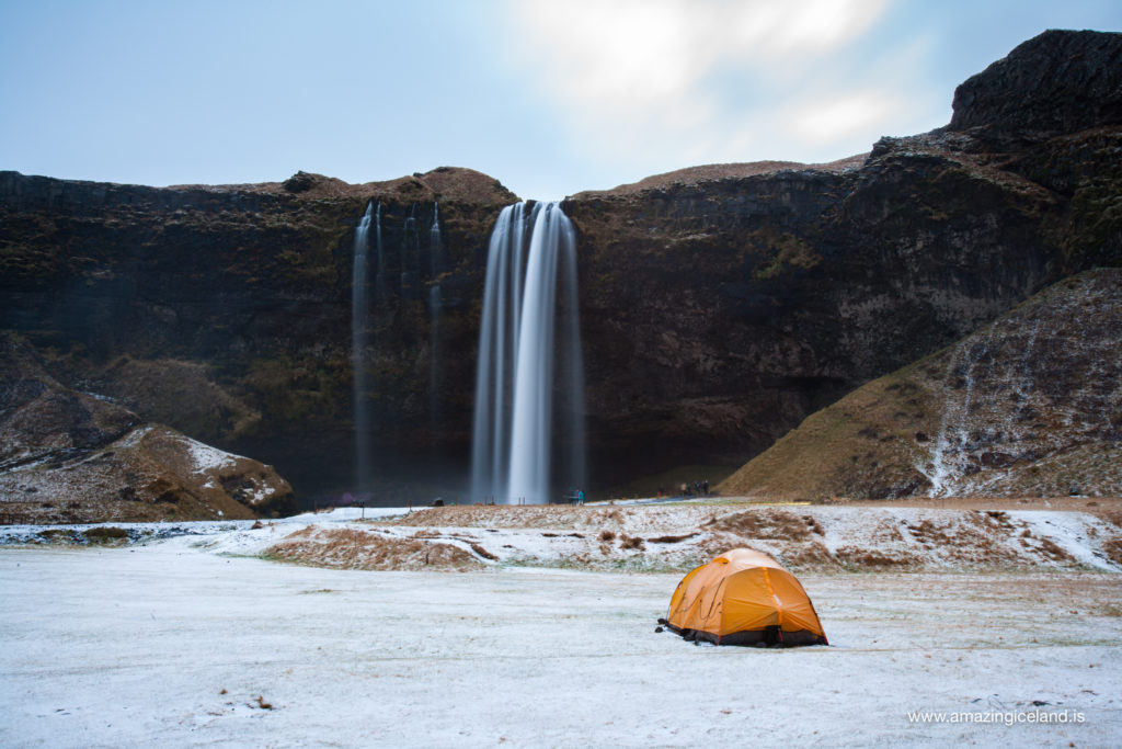 Winter tent camping by Seljalandsfoss waterfall