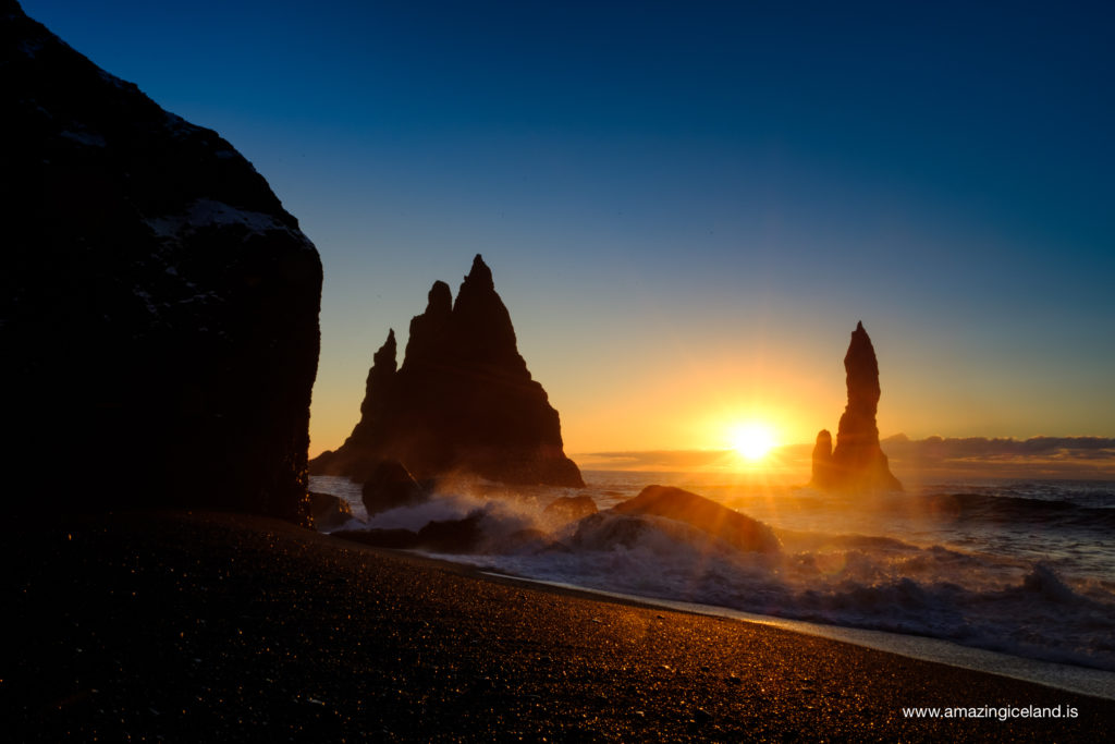 Reynisdrangar basalt columns at sunset on black sand beach in Iceland