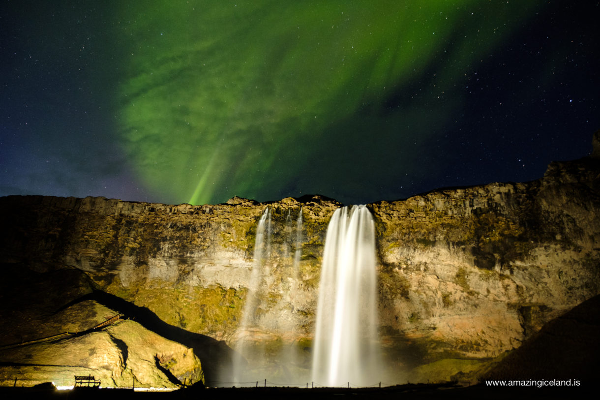 Aurora borealis over Seljalandsfoss waterfall on the south coast of Iceland