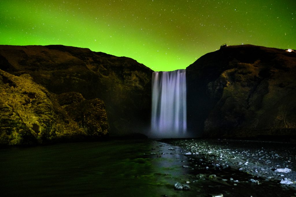 Northern lights over Skogafoss waterfall on south coast of Iceland