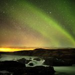 Northern lights over Urriðafoss waterfall on south coast of Iceland