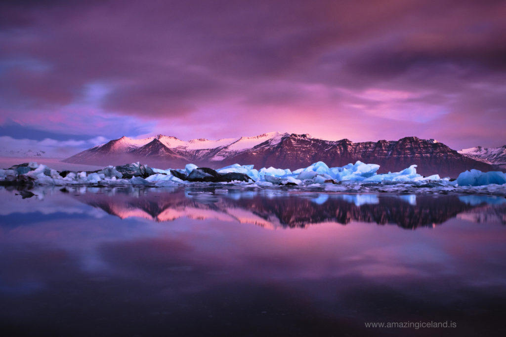 Reflection of icebergs in morning glow at Glacier lagoon in Iceland
