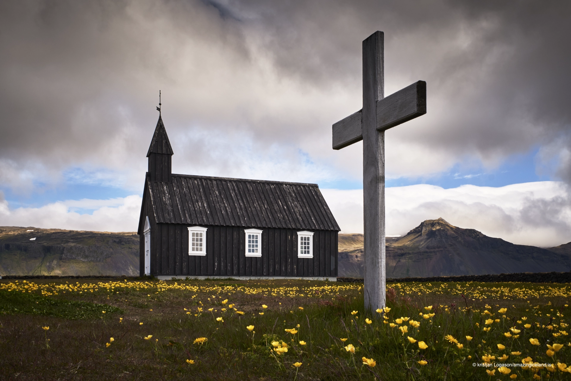 Black church at Budir in Snæfellsnes and a cross
