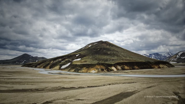 Landmannalaugar is one of Iceland’s most geologically expressive landscapes: a highland basin of rhyolite mountains, lava fields, geothermal activity, and braided rivers within the Fjallabak Nature Reserve. Located at the northern end of F208, the area is internationally known for its colour-rich mountains and natural hot spring, but its deeper significance lies in how clearly it reveals the interaction between volcanism, tectonics, water, and time.