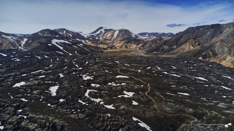 Landmannalaugar is one of Iceland’s most geologically expressive landscapes: a highland basin of rhyolite mountains, lava fields, geothermal activity, and braided rivers within the Fjallabak Nature Reserve. Located at the northern end of F208, the area is internationally known for its colour-rich mountains and natural hot spring, but its deeper significance lies in how clearly it reveals the interaction between volcanism, tectonics, water, and time.