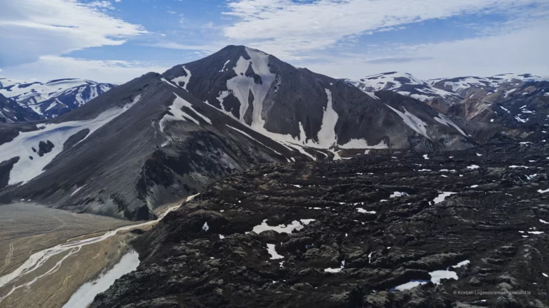 Laugahraun is a young basaltic lava field at Landmannalaugar, formed during the 1477 Veiðivötn eruption. Dark, fractured, and still sharply textured, it stands in direct contrast to the surrounding rhyolite mountains and geothermal slopes. More than a backdrop, Laugahraun is a defining structural element of the Landmannalaugar landscape, shaping access, water flow, and human movement through the area.