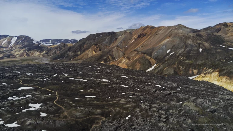 Laugahraun is a young basaltic lava field at Landmannalaugar, formed during the 1477 Veiðivötn eruption. Dark, fractured, and still sharply textured, it stands in direct contrast to the surrounding rhyolite mountains and geothermal slopes. More than a backdrop, Laugahraun is a defining structural element of the Landmannalaugar landscape, shaping access, water flow, and human movement through the area.