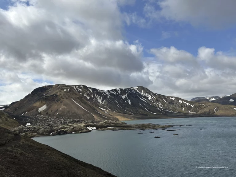 Frostastaðavatn is a shallow highland lake within the Fjallabak Nature Reserve, located directly beside F208 just south of Landmannalaugar. Surrounded by rhyolite mountains, lava fields, and geothermal terrain, the lake is less about dramatic scale and more about balance—water acting as a reflective pause within one of Iceland’s most geologically complex regions.