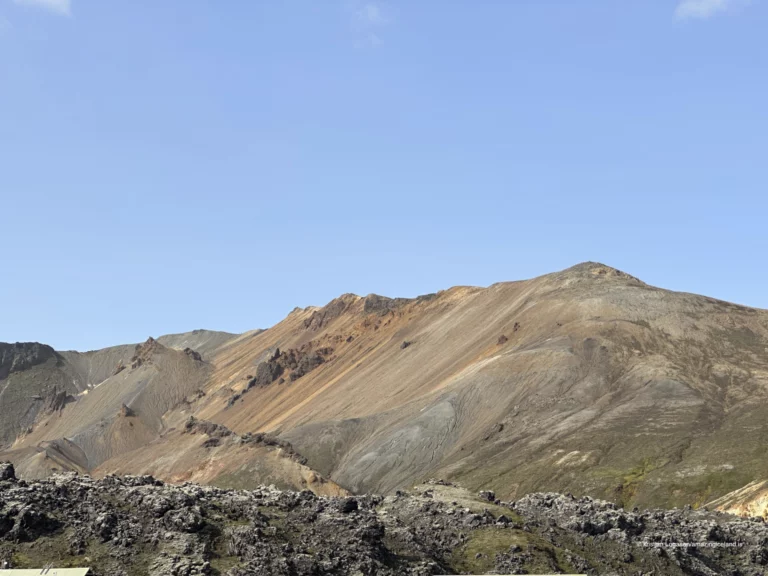 Laugahraun is a young basaltic lava field at Landmannalaugar, formed during the 1477 Veiðivötn eruption. Dark, fractured, and still sharply textured, it stands in direct contrast to the surrounding rhyolite mountains and geothermal slopes. More than a backdrop, Laugahraun is a defining structural element of the Landmannalaugar landscape, shaping access, water flow, and human movement through the area.